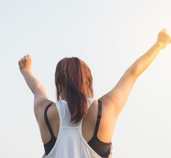 Stylized Photo of Woman With Arms Stretched Up Celebrating